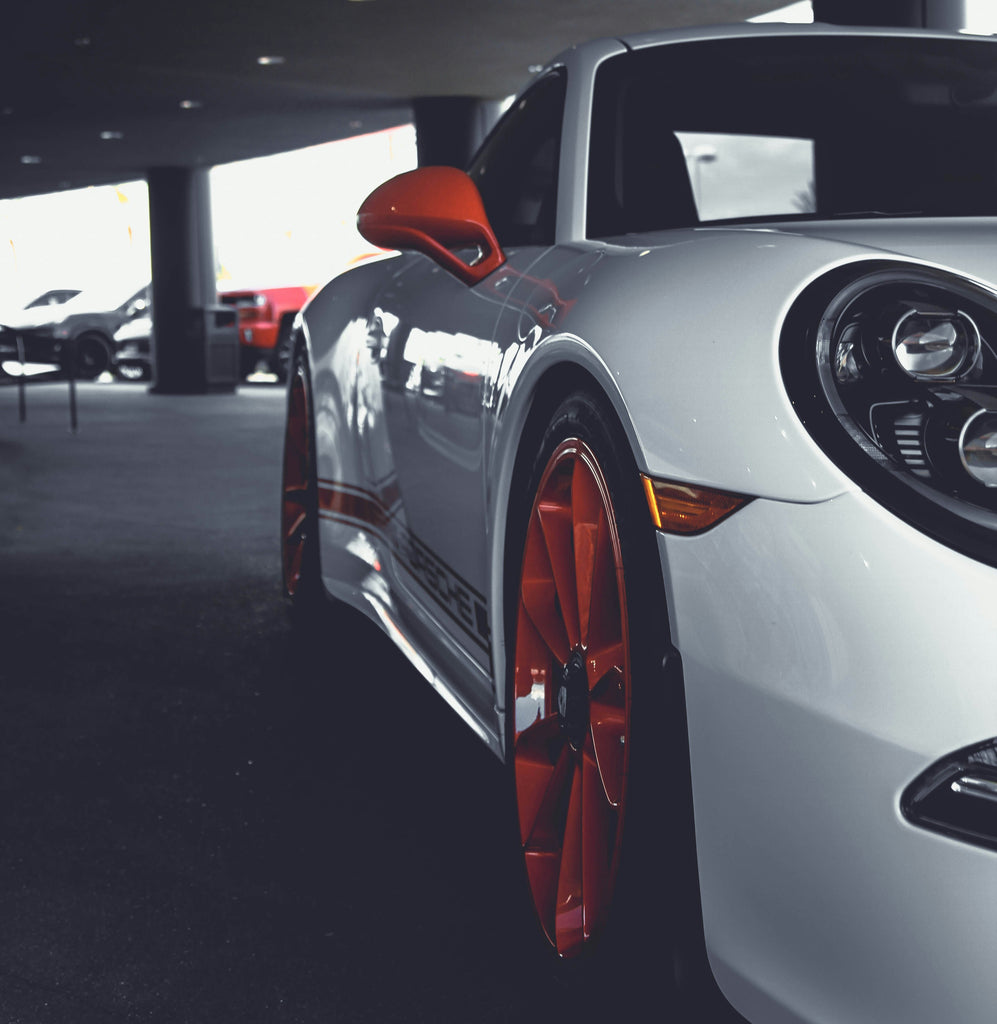 clean porsche with colored rims. microfiber cloth for the perfect streak-free finish.